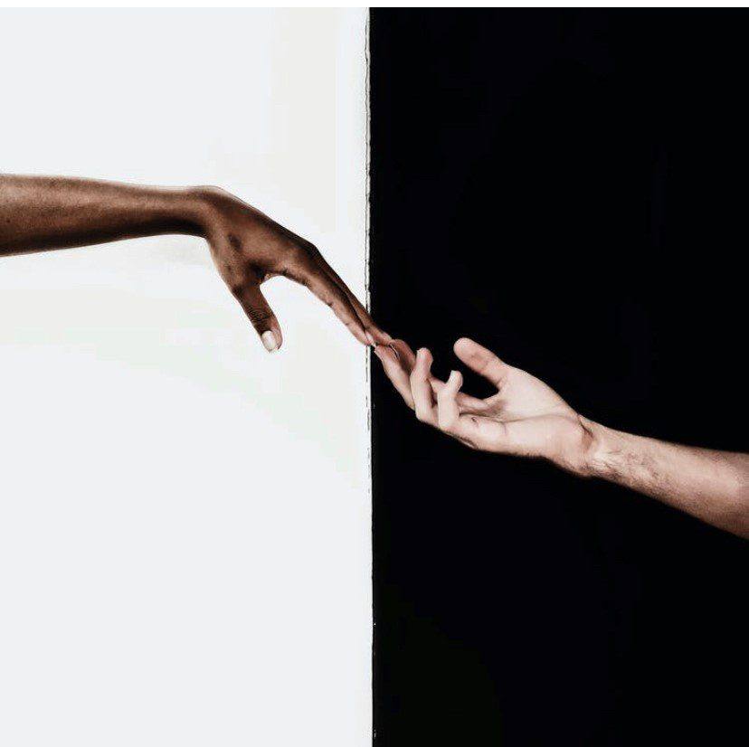 One hand reaching down to help another